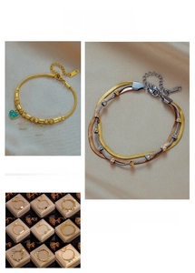 Detailed views of gold-plated stainless steel charm bracelets on soft silk background
