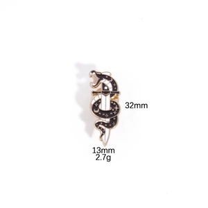 Detail view of black enamel snake and sword pin showing 32mm by 13mm dimensions