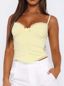 Detail of pale yellow Y2K camisole featuring ruffle trim and front bow tie detail
