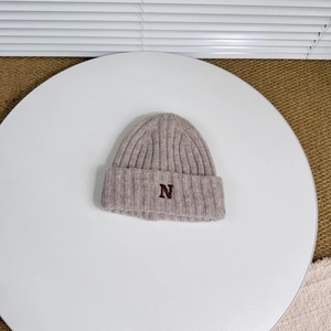 Close-up of letter N embroidery on double-layered thick knitted wool winter hat