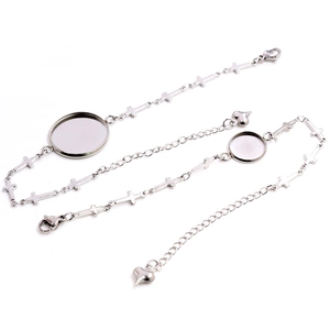 Detailed view of stainless steel cross bracelet with round bezel and heart pendant