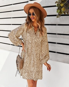 Detail of leopard print V-neck dress featuring a tiered hem and long sleeves