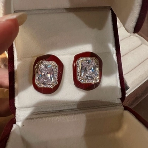 Elegant gold earrings with red drip oil finish and center crystals in a gift box