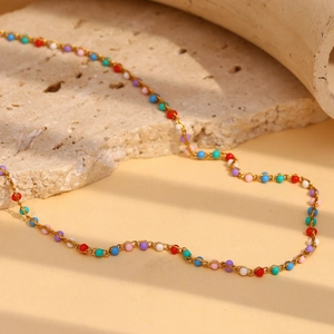 Detailed view of 18K gold plated beaded chain with colorful drip oil beads on stone
