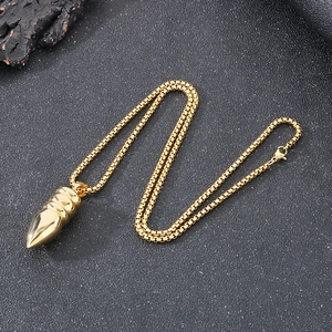 Polished gold bullet pendant necklace with a box chain on a grey textured background