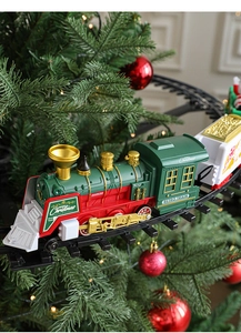 Close-up of retro electric Christmas train with red and green carriages on tree track