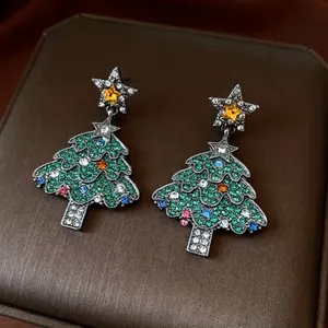 Vintage Christmas tree pendant earrings with colorful rhinestones on a dark base