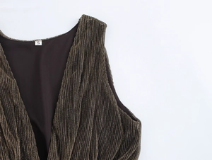 Detail of deep V-neck sleeveless dress showing brown pleated fabric and size S label