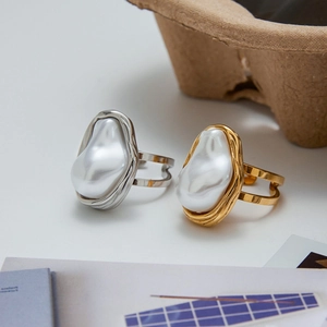 Adjustable baroque pearl ring in gold and silver finish with textured lava metal band