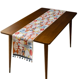 Chenille table runner with colorful hand-painted fish patterns and decorative tassels