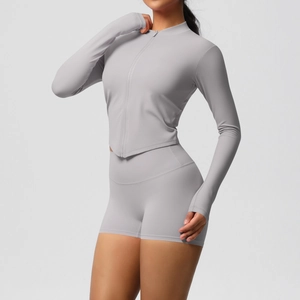Detail of grey yoga set showing thumb hole design on long sleeves and high waist fit