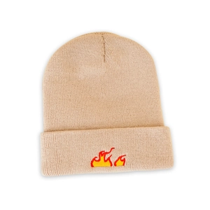Close-up of flame embroidery detail on a warm beige knitted beanie for autumn