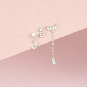Close-up of S925 sterling silver earrings set with blue star and moon zircon pendants