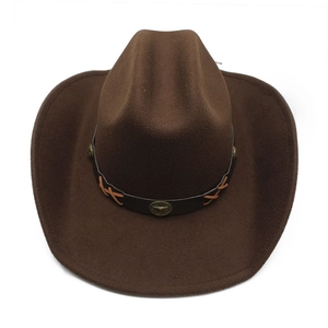 Macro view of brown wool felt cowboy hat featuring metallic bull head ornament