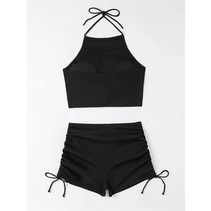 Detail of black halter bikini with drawstring side ruching and back tie closure