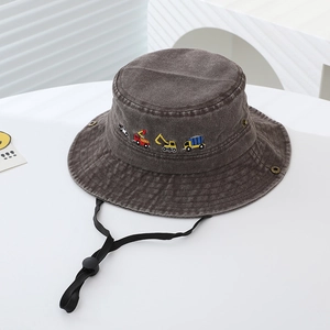Detail view of cotton sun hat for kids featuring colorful excavator embroidery and chin strap
