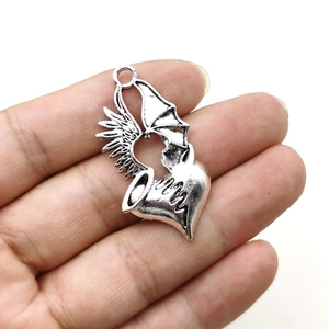 Gothic winged heart pendant in alloy with angel and demon wings on a white background