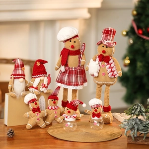 Christmas gingerbread man plush dolls and gnome ornaments in warm holiday setting