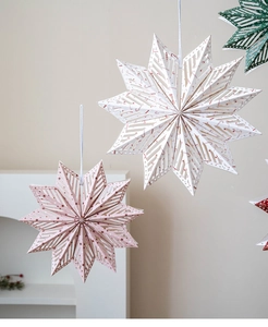 Detailed view of Nordic 3D paper snowflakes with intricate laser-cut patterns for decor
