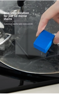 Detail showing blue magic sponge cleaning limescale off a glass lid for crystal clear surface