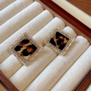 Macro shot of square leopard print earrings with double-row sparkling crystal halo detail