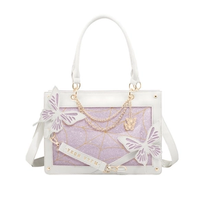 Detailed view of white butterfly tote bag with purple glitter and golden spider web motifs