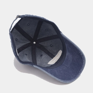 Detail view of washed blue baseball cap interior showing inner tape and metal buckle