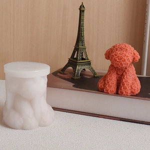 Detailed macro of a rose petal textured dog silicone mold and pink resin puppy model