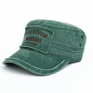 Detail of washed green cadet cap with vintage embroidery and metal eyelets on cotton fabric