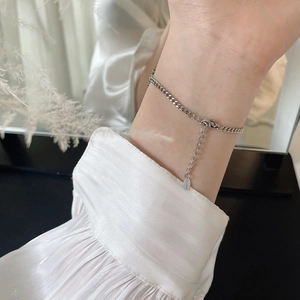 Detail showing the adjustable stainless steel chain and lobster clasp of the silver bracelet