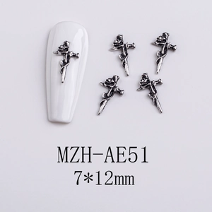 Detailed silver sword and rose metal nail charms on white acrylic nail surface