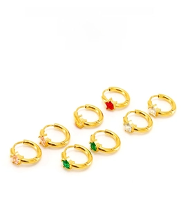 Detail of star-shaped zircon huggie earrings in pink, red, green, and white colors
