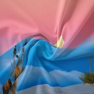 Detailed macro view of the silky fabric texture and sunset landscape print on tapestry