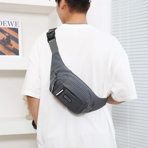 Waterproof large capacity dark grey nylon waist bag worn as crossbody pack on model