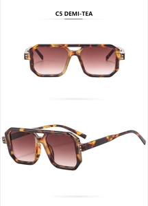 Detail view of tortoiseshell aviator sunglasses with brown gradient lenses and double bridge