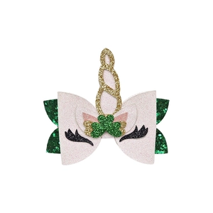 Detail of St. Patrick's Day glitter unicorn hair clip with green shamrock and gold horn