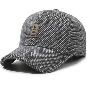 Winter baseball cap for men with warm earflaps and grey tweed wool texture and leather label