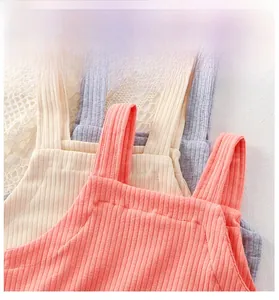 Detailed view of soft ribbed cotton baby bodysuits with wide straps and breathable texture