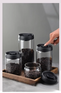 Detailed macro view of four sizes of vacuum sealed glass jars for coffee bean storage