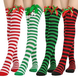 Detail of Christmas striped over-the-knee socks with festive bows and plush pom-poms