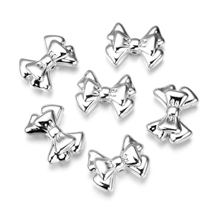 Detailed view of silver acrylic bow beads for DIY phone chains and jewelry making