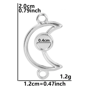Macro detail of crescent moon pendant with round setting and link loops in silver steel