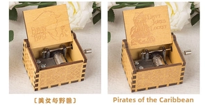 Macro view of vintage hand-cranked wooden music boxes featuring intricate film carvings