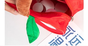 Close-up of red apple shaped cosmetic bag showing large storage capacity for skincare
