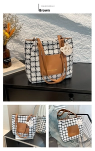 Detail of checkered woolen tote bag with brown leather pocket and cute tiger charm