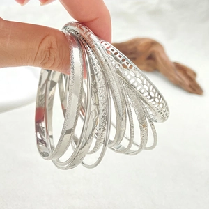 Detailed view of bohemian silver bangles featuring polished finish and hammered textures