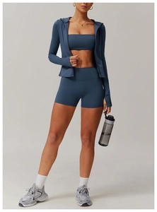 Close-up of three-piece grey blue yoga set featuring a zip hoodie and high-waist shorts
