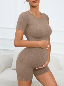 Detailed side view of coffee brown seamless ribbed maternity jumpsuit for yoga and fitness