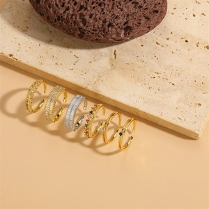 Set of six adjustable gold and silver rings with colorful cubic zirconia on stone base