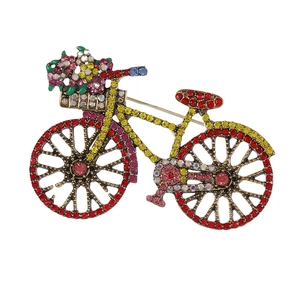 Retro rhinestone bicycle brooch with colorful crystals on a white background